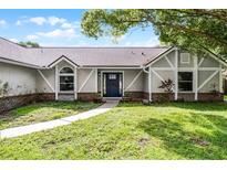 Charming single-story home with Tudor accents, fresh landscaping, and inviting entryway at 3015 Riviera Bay Ct, Oviedo, FL 32765