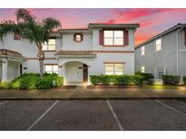 Inviting townhouse showcasing manicured bushes and a palm tree in front, offering a serene living environment at 3193 Pequod Pl, Kissimmee, FL 34746