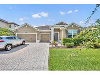 Beautiful single-Gathering home with a well-manicured lawn, three-car garage, and paved driveway on a sunny day at 3454 Somerset Park Dr # 36, Orlando, FL 32824