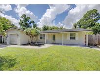 Inviting exterior of a cozy home with a lush green lawn and an attached garage at 422 S Hawthorn Cir, Winter Springs, FL 32708