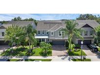 Beautiful two-story home with a paver driveway, lush landscaping, and a two-car garage at 617 Marsh Reed Dr, Winter Garden, FL 34787