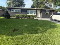 Charming single-story home features a well-manicured lawn and tidy landscaping at 740 Naples Dr, Orlando, FL 32804