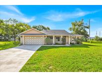 Charming single-story home with a well-manicured lawn and attached two-car garage at 910 Amy Ridge Ct, Kissimmee, FL 34747