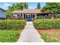 Charming bungalow featuring a well-manicured lawn, lush landscaping, and a welcoming front porch at 110 N Brown Ave, Orlando, FL 32801