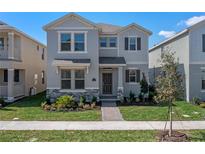 Charming two-story home with stone accents, manicured lawn, and inviting front entrance at 11188 Hollow Bay Dr, Winter Garden, FL 34787