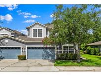 Charming two-story home featuring an attached two-car garage and a well-manicured front yard at 1461 Travertine Ter, Sanford, FL 32771