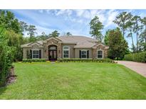 Beautiful single-story home featuring stone accents and a well-manicured front lawn at 1462 Palm Bay Ct, Lake Mary, FL 32746