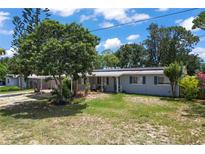 Charming single-story home with blue shutters and lush landscaping, perfect for curb appeal at 1963 Forest Ave, Daytona Beach, FL 32119