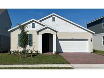 Charming single-story home with a two-car garage and a well-manicured front yard at 2043 Town Pasture Dr, Eustis, FL 32726