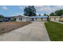Charming single-story home with a well-manicured lawn, a new roof, and a long driveway at 215 Rydalmont Rd, Winter Haven, FL 33884