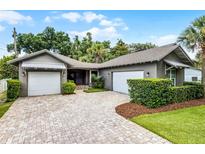 Charming home featuring an attractive brick driveway, two-car garage, and beautiful landscaping at 3601 S Summerlin Ave, Orlando, FL 32806