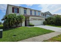 Charming two-story home with a well-manicured lawn and inviting curb appeal at 438 Janice Kay Pl, Kissimmee, FL 34744