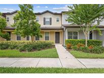 Charming two-story townhome with manicured landscaping, healthy plants, and a welcoming walkway at 5030 Caspian St, St Cloud, FL 34771