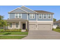 Charming two-story home with a well-manicured lawn and a spacious three-car garage at 9535 Beautiful Way, Winter Garden, FL 34787