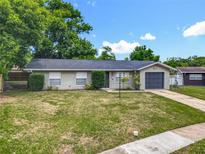 Charming single-story home featuring well-maintained landscaping and an attached garage at 117 Burns Ave, Longwood, FL 32750