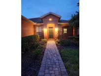 Charming front entrance with brick walkway and well-maintained landscaping provides curb appeal at 152 Glendale Ct, Kissimmee, FL 34759