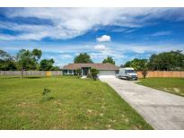 Charming single-story home boasts a well-manicured lawn, long driveway, and a bright, inviting exterior at 17927 E Apshawa Rd, Minneola, FL 34715