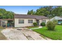 Charming single-story home featuring a brick exterior, well-maintained lawn, and covered parking at 3702 Starks St, Orlando, FL 32805
