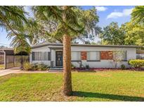 Charming single-story home featuring mature landscaping and a well-maintained front yard at 414 W 19Th St, Sanford, FL 32771