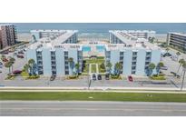 Stunning aerial view of the oceanfront condo complex with community pool and manicured grounds at 4151 S Atlantic Ave # 5110, New Smyrna Beach, FL 32169