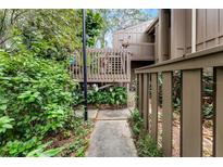 Inviting home exterior featuring a private entry deck surrounded by lush landscaping at 5310 Pebble Beach Dr # F, Orlando, FL 32811