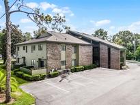 A multi-story condo with brick and siding exterior, with a parking lot in the front at 538 W Par St # 538, Orlando, FL 32804