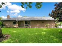 Charming single-story home with a large front lawn, mature trees, and well-maintained landscaping at 545 Mystic Wood St, Casselberry, FL 32707