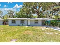 Charming single-story home featuring a cozy carport and a well-maintained front lawn at 606 Washington St, Daytona Beach, FL 32114