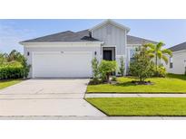 Charming single-story home with a manicured lawn and a two-car garage at 1025 Augustus Dr, Davenport, FL 33896