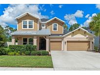 Beautiful two-story home featuring a manicured lawn, three-car garage, and tasteful curb appeal at 1224 Hillcrest View Loop, Apopka, FL 32703