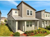 Charming two-story home featuring a modern design with neutral tones, well-maintained landscaping, and a welcoming front porch area at 172 S Zuni Rd, St Cloud, FL 34771