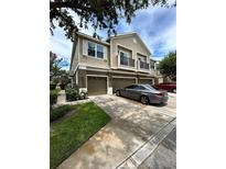 Charming townhouse with a two-car garage and a well-manicured lawn and balcony at 1984 Estancia Circle # 29A, Kissimmee, FL 34741