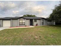 Charming single-story home featuring a well-manicured lawn and neutral-colored exterior at 258 Magellan Dr, Kissimmee, FL 34758