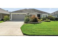 Well-maintained home featuring manicured landscaping and a neutral color palette at 2895 Apache Ct, The Villages, FL 32163
