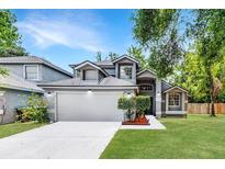 Charming two-story home with a well-maintained lawn, gray exterior and a two car garage at 333 Sonoma Valley Cir, Orlando, FL 32835