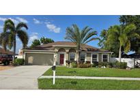 Charming single-story home with a well-manicured lawn, mature landscaping, and a two-car garage at 4905 Newton Ct, St Cloud, FL 34771