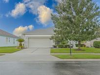 Charming home featuring a two-car garage and meticulously maintained landscaping, enhancing curb appeal at 5353 Red Leaf Ct, Oviedo, FL 32765