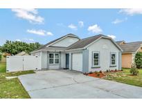 Charming single-story home featuring a well-manicured lawn and a convenient attached garage at 601 Swallow Ct, Apopka, FL 32712