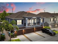 Beautiful exterior elevation of a two-story home with a large driveway and attached garage at 6566 S Goldenrod Rd # 82A, Orlando, FL 32822