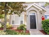 Inviting front entrance with a black door and well-maintained landscaping, creating curb appeal at 9053 Lee Vista Blvd # 1404, Orlando, FL 32829