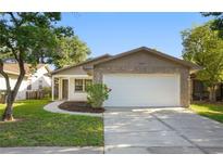 Charming home with a two-car garage, stone accents, and fresh landscaping, ready for move-in at 10519 Wyndcliff Dr, Orlando, FL 32817