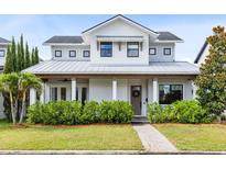 Charming two-story home with a manicured lawn and covered porch with decorative columns at 1410 W New Hampshire St, Orlando, FL 32804
