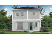 Contemporary two-story home featuring a modern design and a neatly landscaped front yard at 2042 Education St, St Cloud, FL 34771