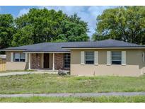 Charming single-story home with tan exterior, brick accents, and a well-manicured front yard at 2078 Keyes Ln, Deltona, FL 32738