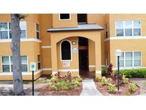 Inviting entrance to the building with well-maintained landscaping and clear signage at 4606 Commander Dr # 1126, Orlando, FL 32822