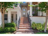 Inviting front entrance with brick steps and black railing, adding curb appeal to the property at 528 Lanark Ct, Orlando, FL 32806
