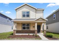 Charming two-story home with stone accents, covered porch, and landscaped front yard at 6449 Sprucepine Ln, St Cloud, FL 34771