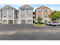 Condominium buildings boast well-maintained landscaping and convenient parking, perfect for easy access to your new home at 12843 Madison Pointe # 208, Orlando, FL 32821