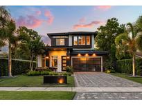 Beautiful two-story home with well-manicured lawn, updated garage door, and gorgeous landscaping at 1541 Chestnut Ave, Winter Park, FL 32789