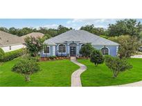Charming single-story home with a well-manicured lawn and inviting walkway at 2865 Ashton Ter, Oviedo, FL 32765